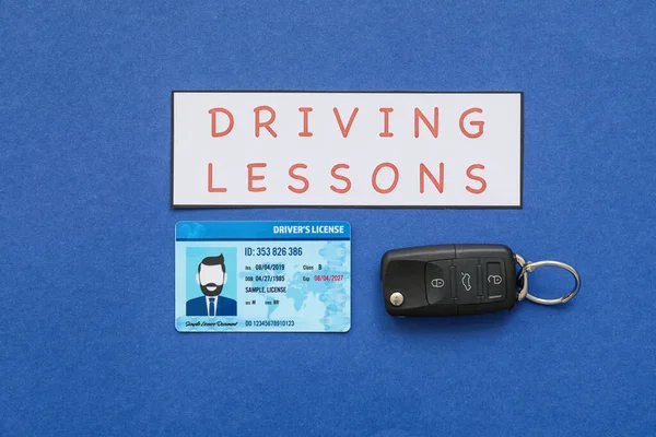 Driving license with car key on color background