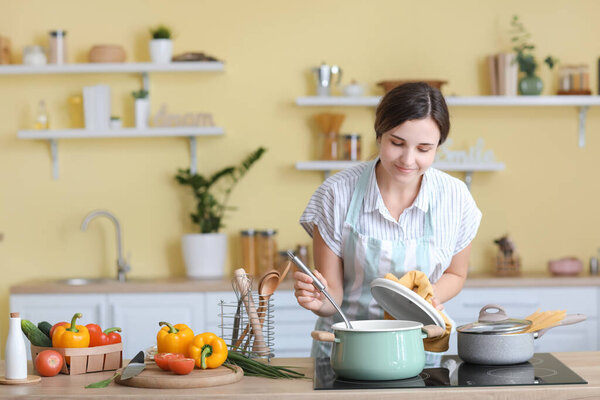 Woman cooking dinner in kitchen