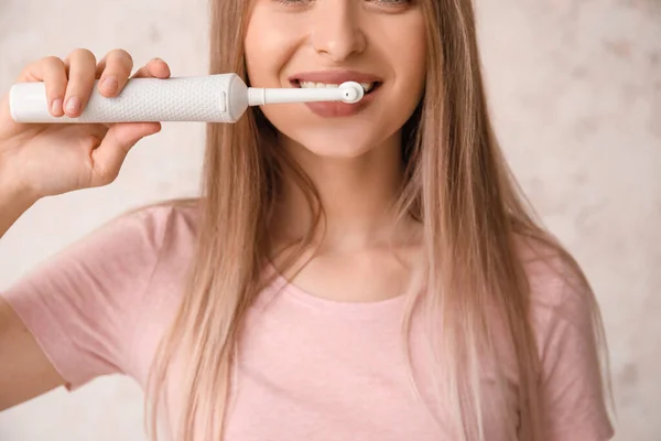 Young Woman Electric Tooth Brush Light Background — Stock Photo, Image