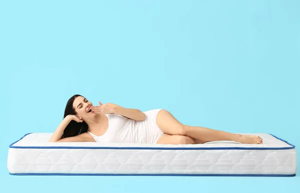 Young Woman Lying Mattress Color Background — Stock Photo, Image