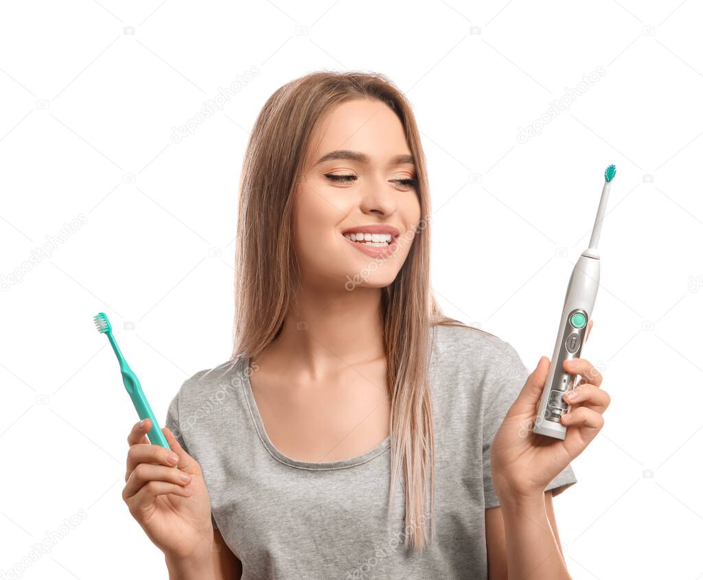 Young woman with different tooth brushes on white background