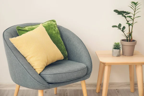 Stylish Armchair Pillows Table Houseplants Light Wall Room —  Fotos de Stock