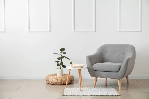 Stylish Armchair Table Books Houseplant Light Wall Room —  Fotos de Stock