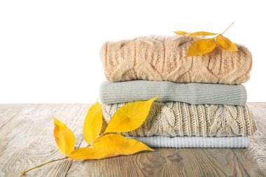 Masadaki sonbahar kıyafetlerini beyaz arkaplana karşı stil et