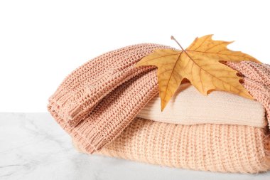 Masadaki sonbahar kıyafetlerini beyaz arkaplana karşı stil et