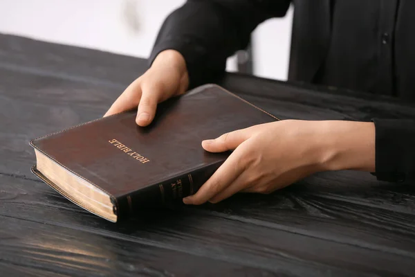 Man Holding Holy Bible Wooden Table — Stock Photo, Image