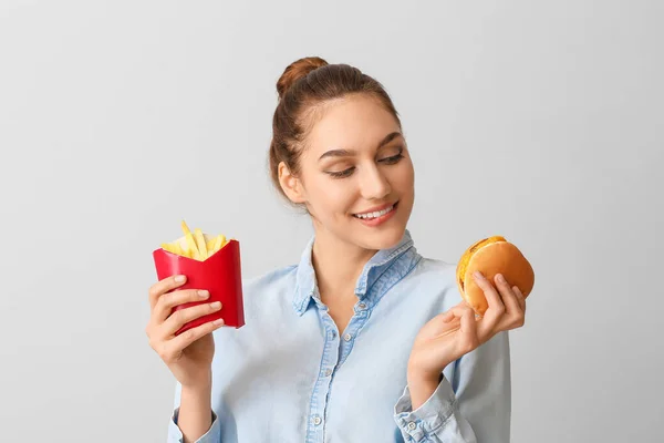 Young Woman French Fries Burger Light Background — Stock Photo, Image