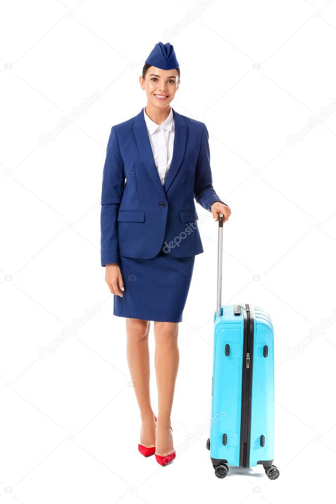 Beautiful stewardess with luggage on white background