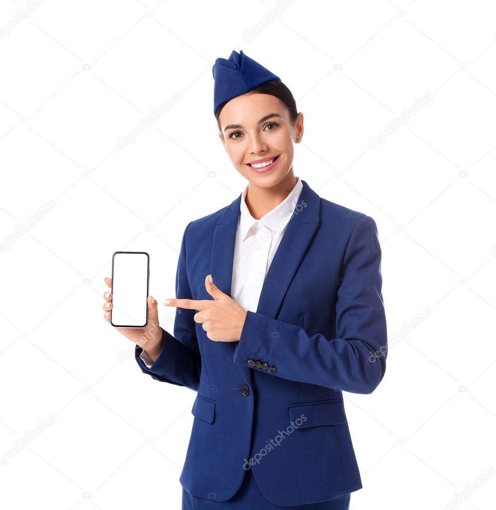 Beautiful stewardess with mobile phone on white background