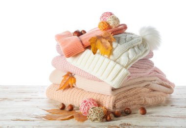 Masadaki sonbahar kıyafetlerini beyaz arkaplana karşı stil et