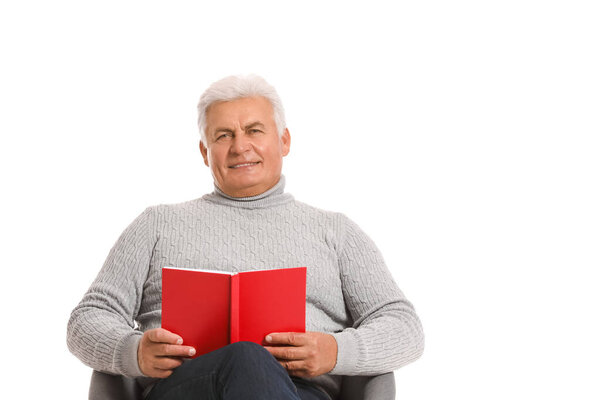 Mature man reading book on white background