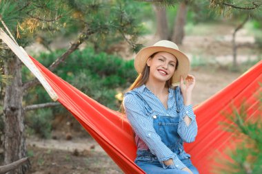 Hamakta dinlenen genç ve güzel bir kadın.