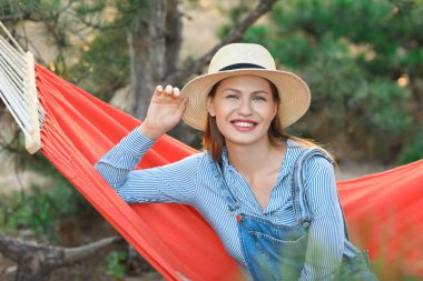 Hamakta dinlenen genç ve güzel bir kadın.