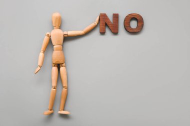 Gri arka planda HAYIR sözcüğüyle tahta manken