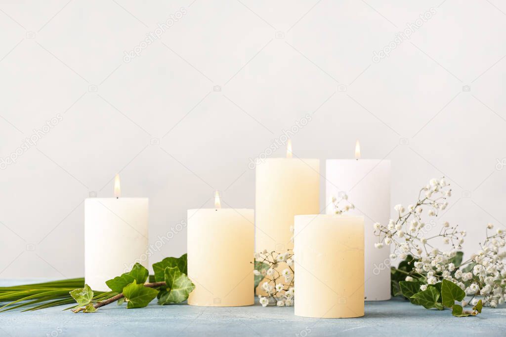 Beautiful aroma candles on table in room