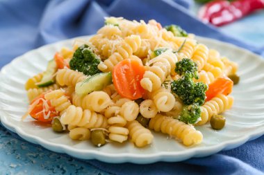 Tabak lezzetli makarna primavera ile masada, yakın plan.