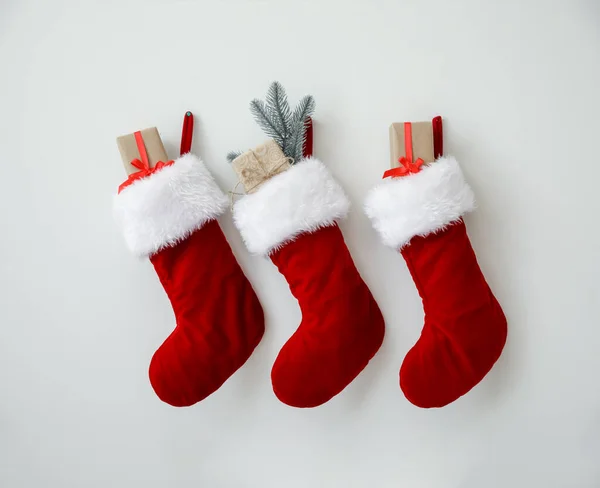 Όμορφες Χριστουγεννιάτικες Κάλτσες Δώρα Που Κρέμονται Στον Ελαφρύ Τοίχο — Φωτογραφία Αρχείου