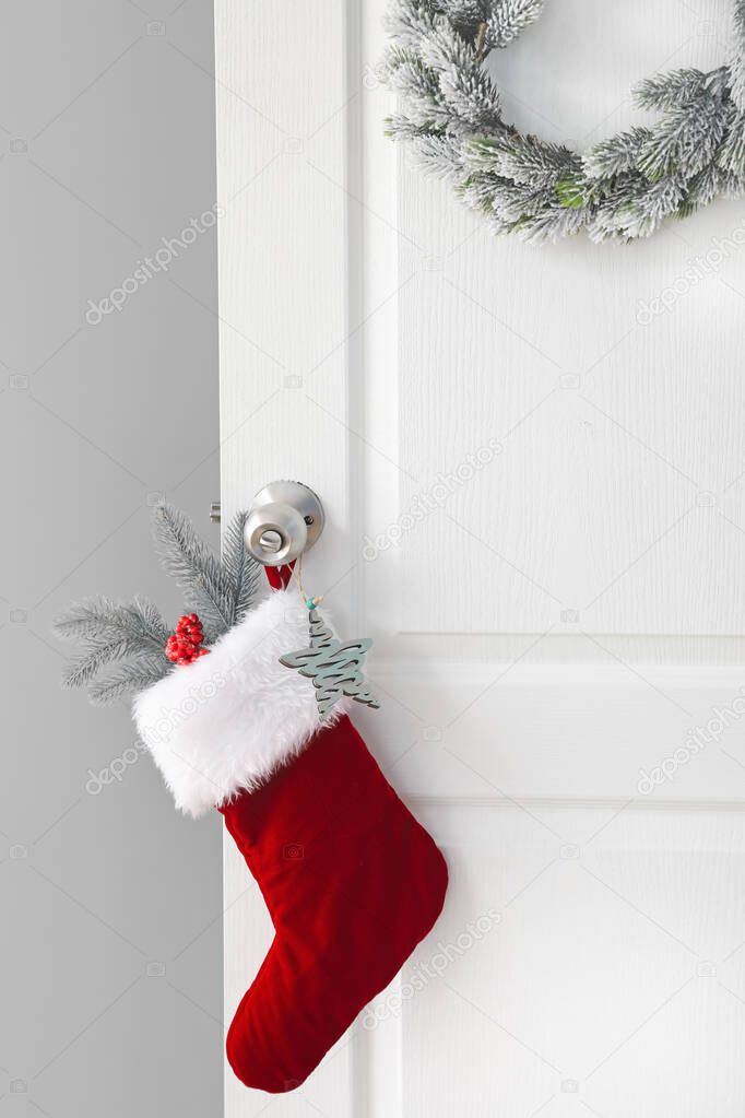 Beautiful Christmas sock hanging on white door