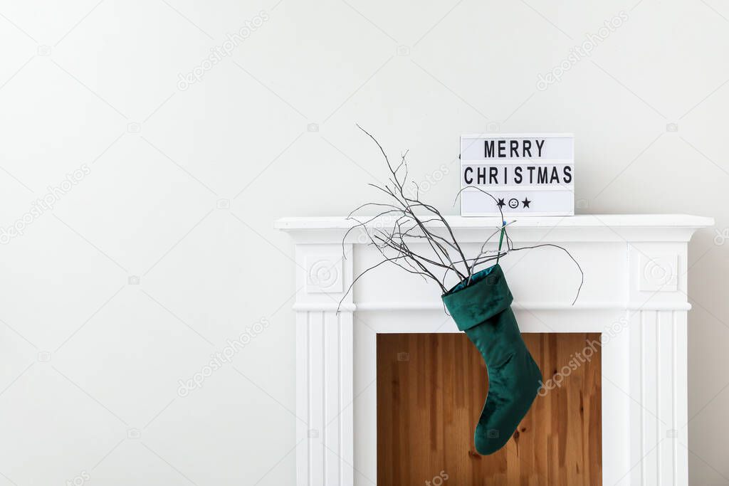 Beautiful Christmas sock hanging on fireplace in room