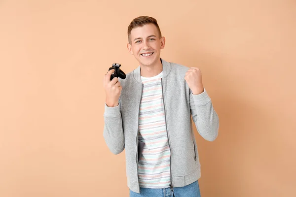 幸せな若い男がビデオゲームをプレイする色の背景 — ストック写真