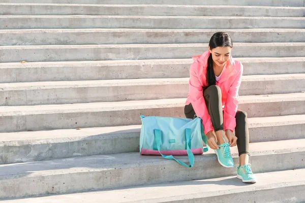 Sporty Young Woman Tying Shoelaces Outdoors — Stock Photo, Image