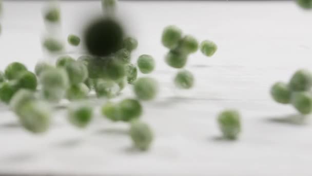 Scattering Frozen Peas White Wooden Table Closeup — Stock Video
