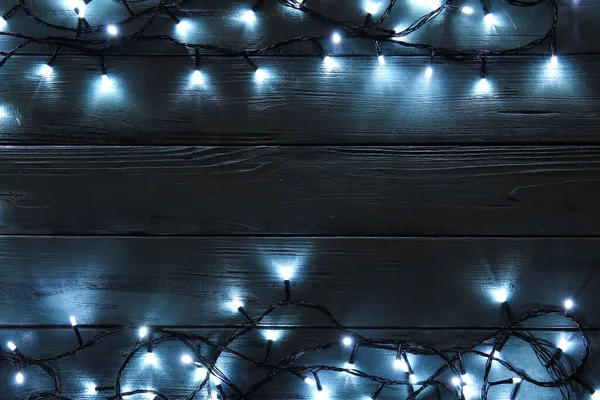 Glowing Christmas Lights Dark Wooden Background — Stock Photo, Image