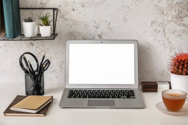 Modern dizüstü bilgisayarı olan rahat bir iş yeri.