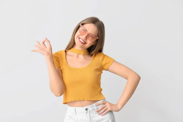 Beautiful Woman Stylish Sunglasses Showing Gesture Light Background — Stock Photo, Image