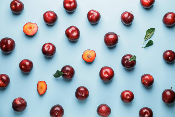 Fresh ripe plums on  color background