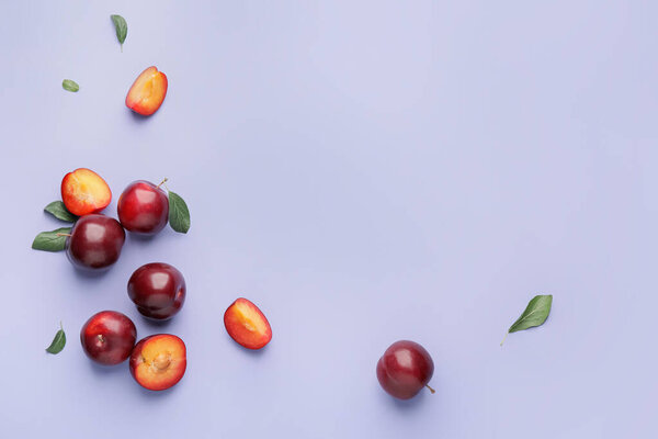Fresh ripe plums on  color background