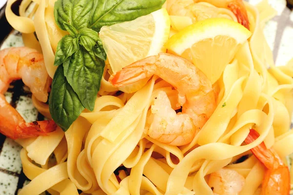 Plate of tasty pasta with shrimps, closeup