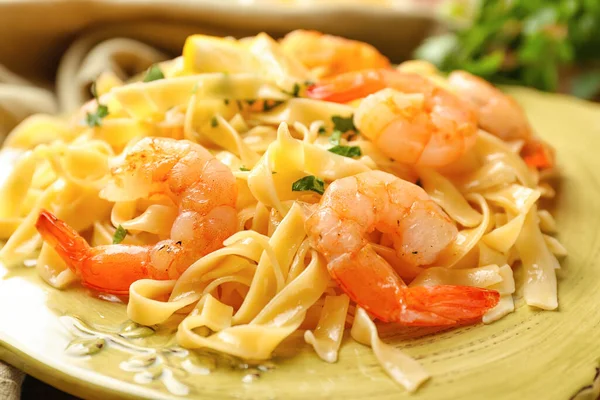 Plate of tasty pasta with shrimps, closeup