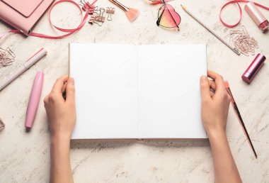 Beyaz arka planda kitap ve aksesuarları olan kadın elleri