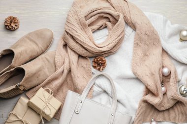 Noel kompozisyonu, ahşap arka planda şık kıyafetler ve aksesuarlar.