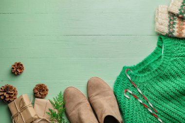 Renkli ahşap arka planda şık kıyafetler ve aksesuarlarla Noel kompozisyonu