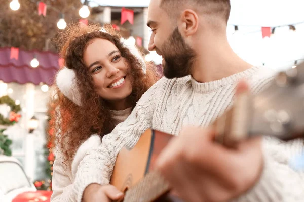 Young Man Playing Guitar His Girlfriend Christmas Eve — Stock Photo, Image