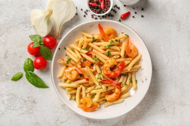 Bir tabak lezzetli makarna ve masada karides.