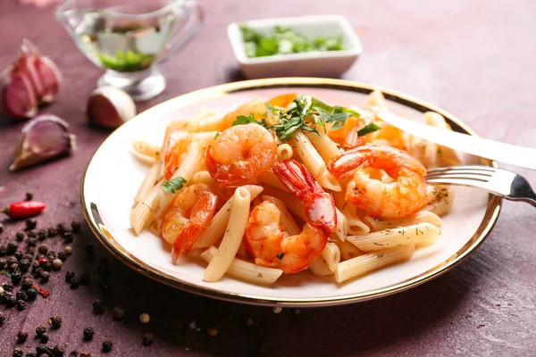 Plate of tasty pasta with shrimps on table