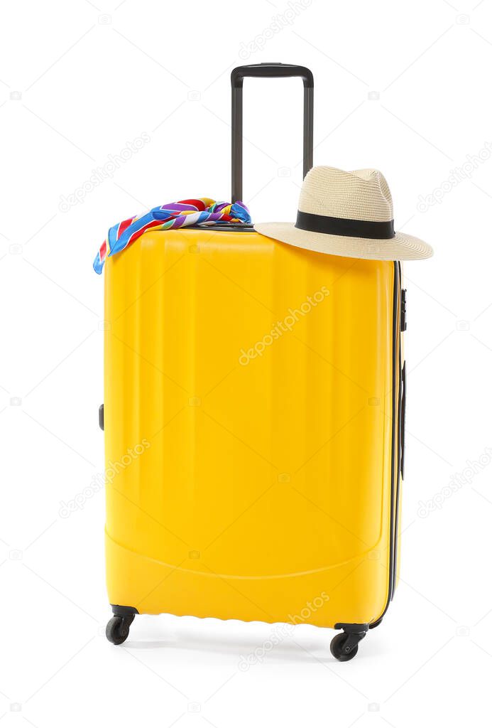 Packed suitcase and hat on white background