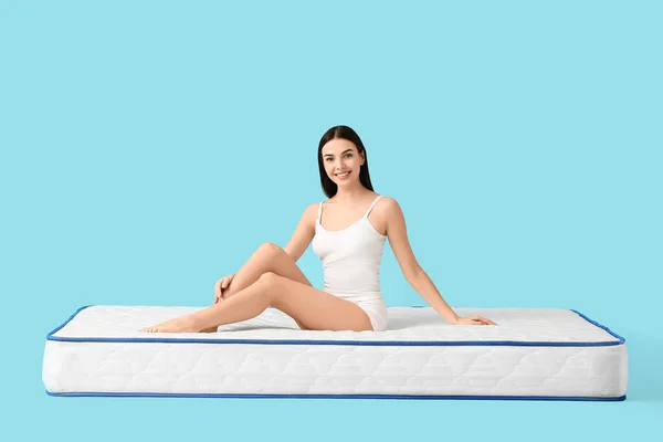 Young Woman Sitting Mattress Color Background — Stock Photo, Image