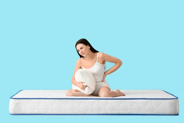 Young Woman Suffering Pain Mattress Color Background — Stock Photo, Image