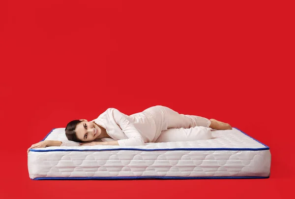 Young Woman Lying Mattress Color Background — Stock Photo, Image