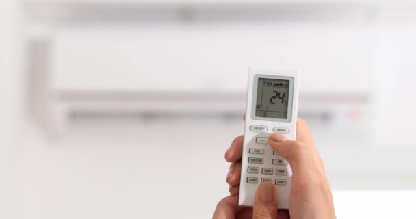 Woman adjusting temperature of air conditioner which is operating in heating mode, closeup — Stock Footage Woman Adjusting Temperature Air Conditioner Which Operating Heating Mode Closeup Stock Footage