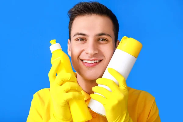 Young Man Cleaning Supplies Color Background — Stock Photo, Image