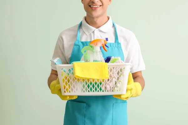 Young Man Cleaning Supplies Color Background — Stock Photo, Image