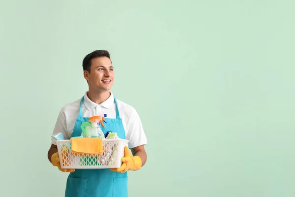 Young Man Cleaning Supplies Color Background — Stock Photo, Image