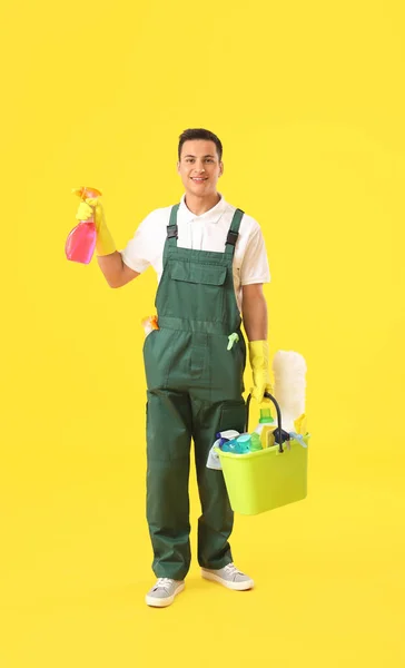 Young Male Janitor Cleaning Supplies Color Background — Stock Photo, Image