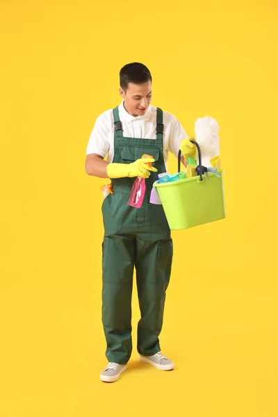 Young Male Janitor Cleaning Supplies Color Background — Stock Photo, Image