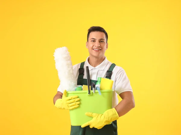 Young Male Janitor Cleaning Supplies Color Background — Stock Photo, Image